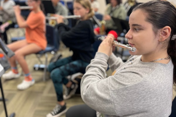 female middle school student playing the flute