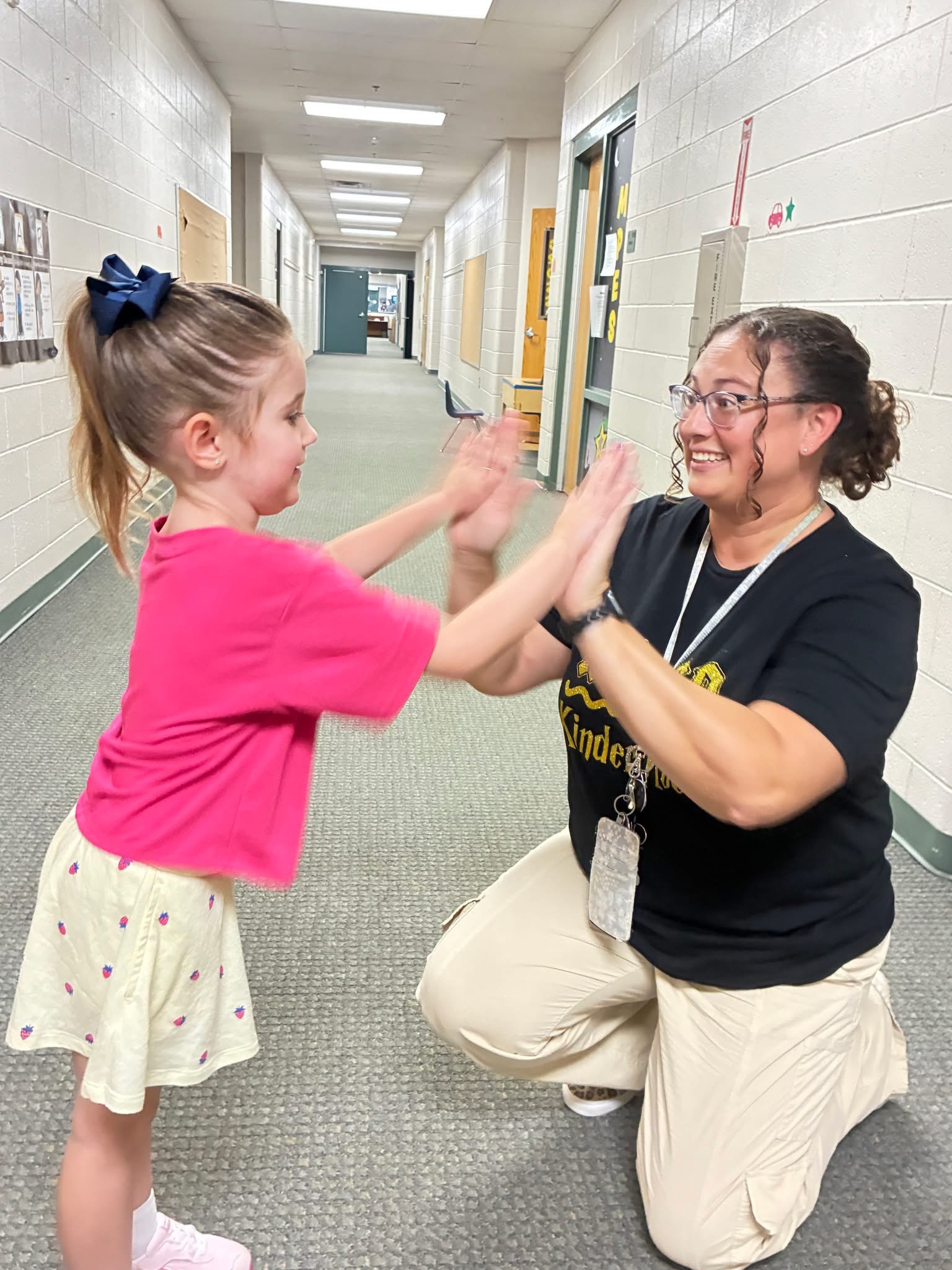 Student giving a teacher a high five