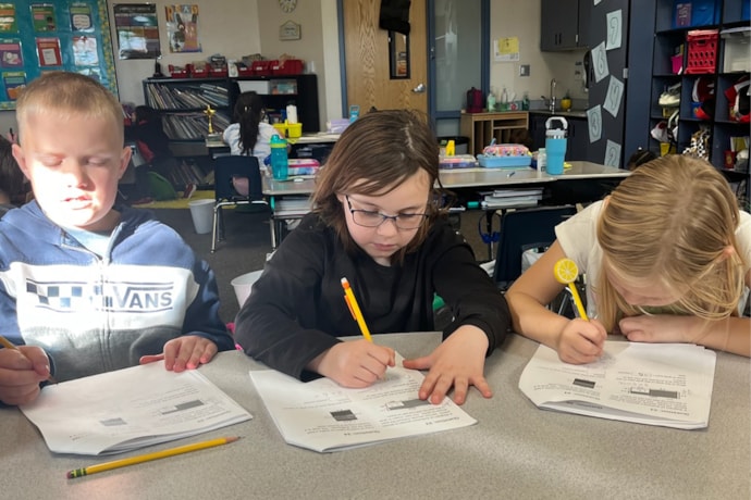 Madeline sitting with 2 other students