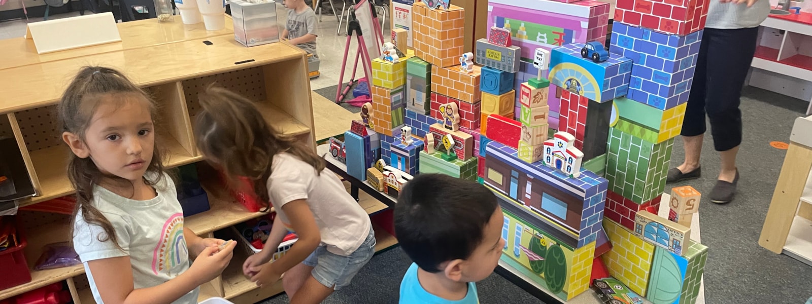 Preschool students creating a building
