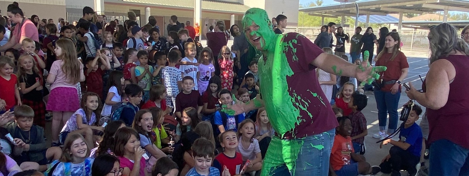 Mr Griesel with slime on him standing with students