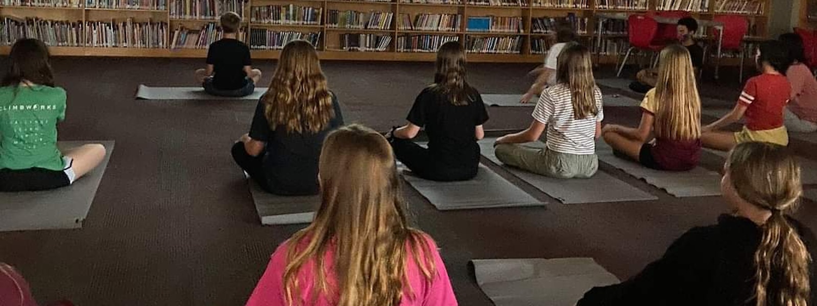 Students sitting on mats for yoga