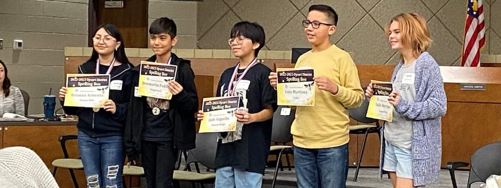 Students holding certificates at the Spelling Bee