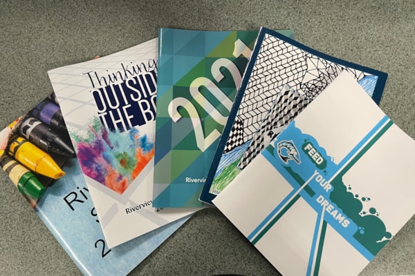 5 yearbooks with different covers 