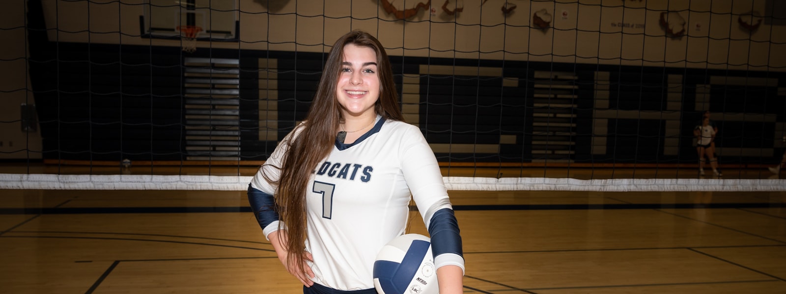 Jordyn Kellick, a volleyball player at Willow Canyon High School, poses for a photograph on the volleyball court.