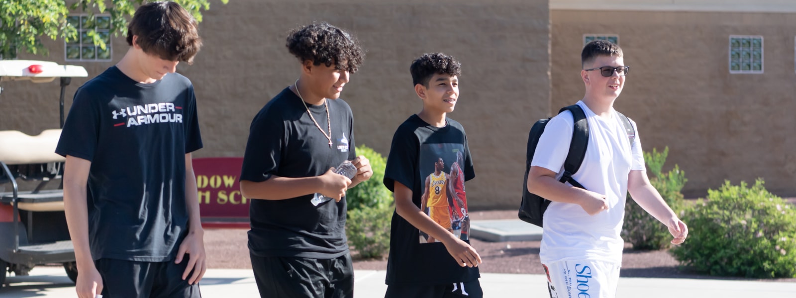 4 males students walking on campus