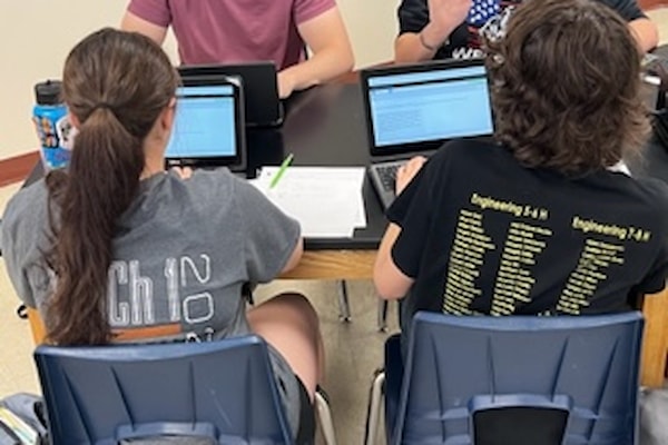 Two students taking their final on their laptop