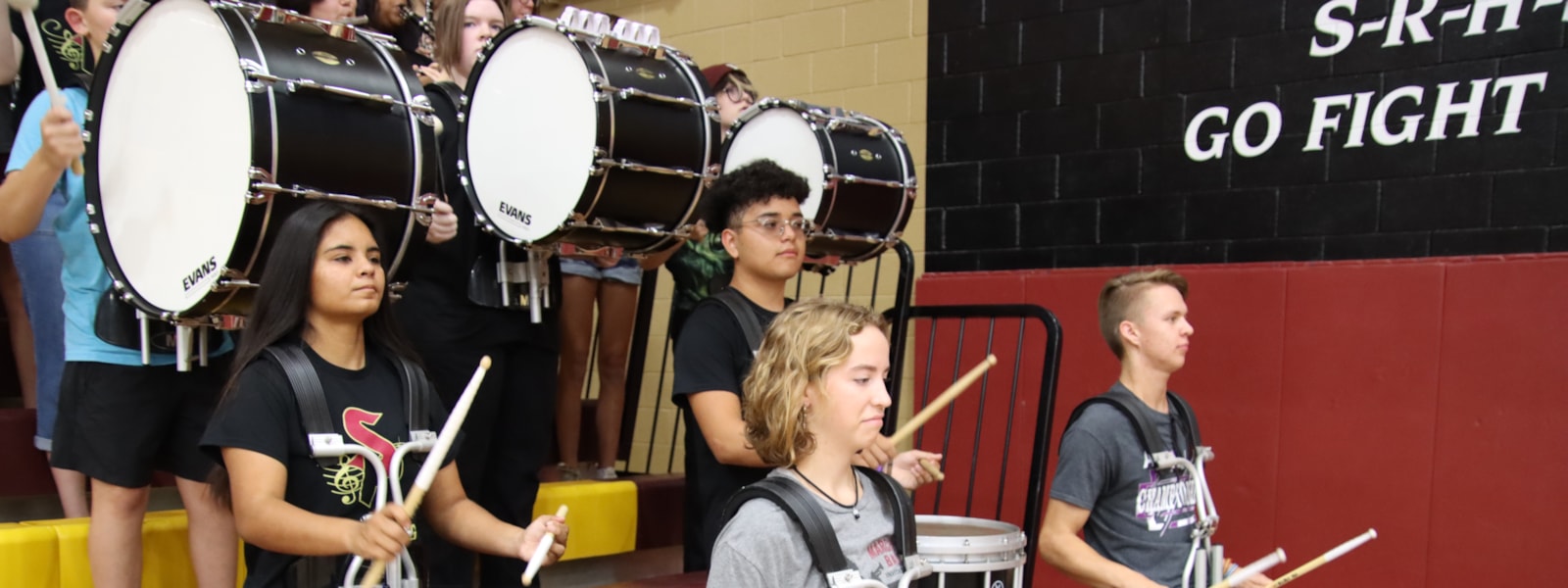 Students in school band playing drums