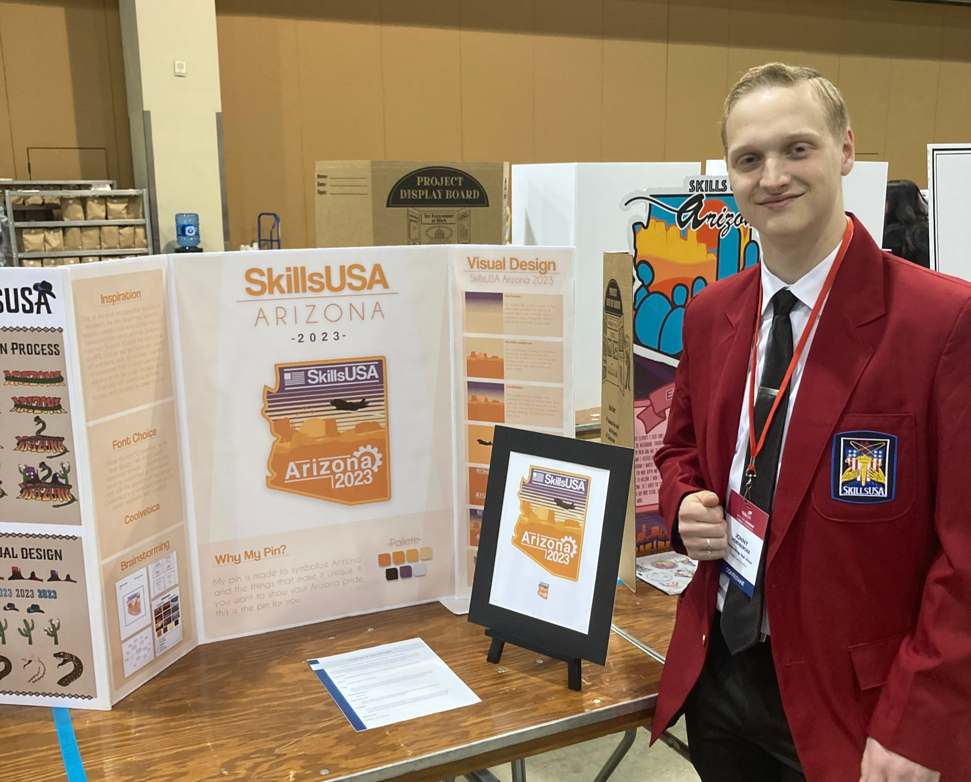 Male student with posters for SkillsUSA