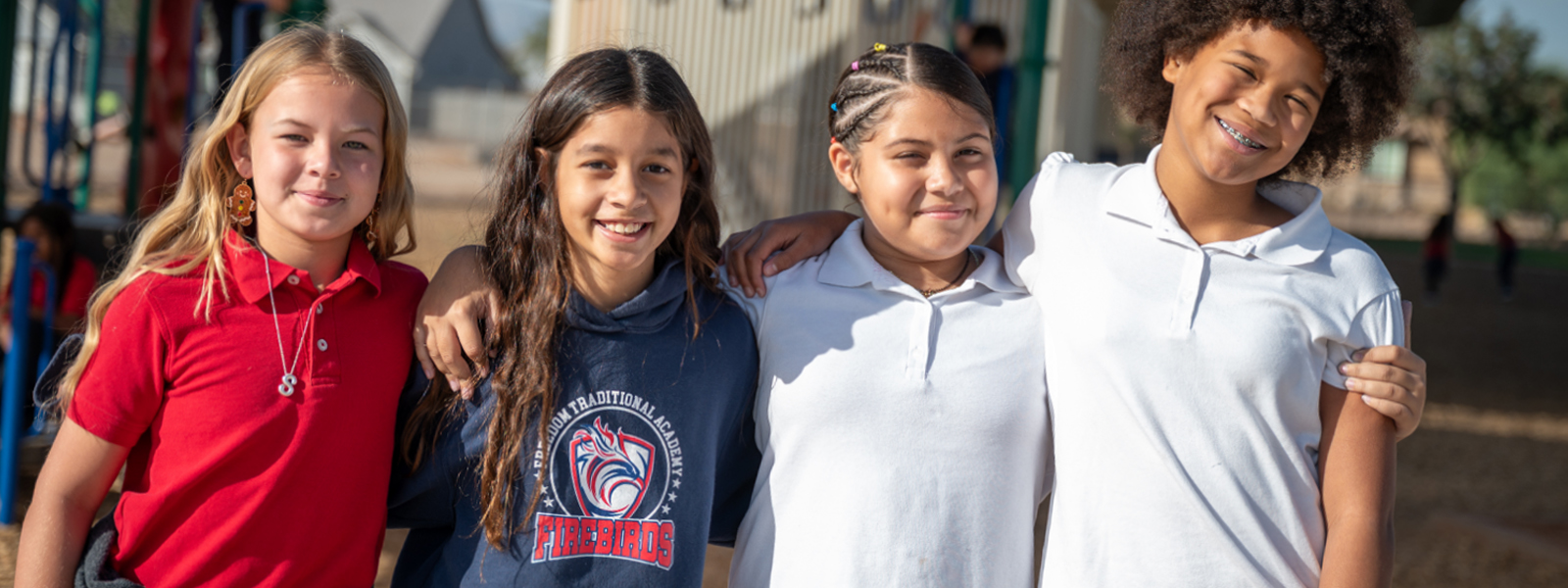 Freedom students posing for the camera on the playground