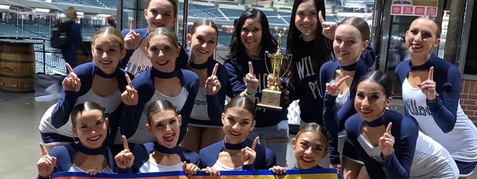 Willow Canyon's Spiritline poses with their trophy and first place banner at the state championships.