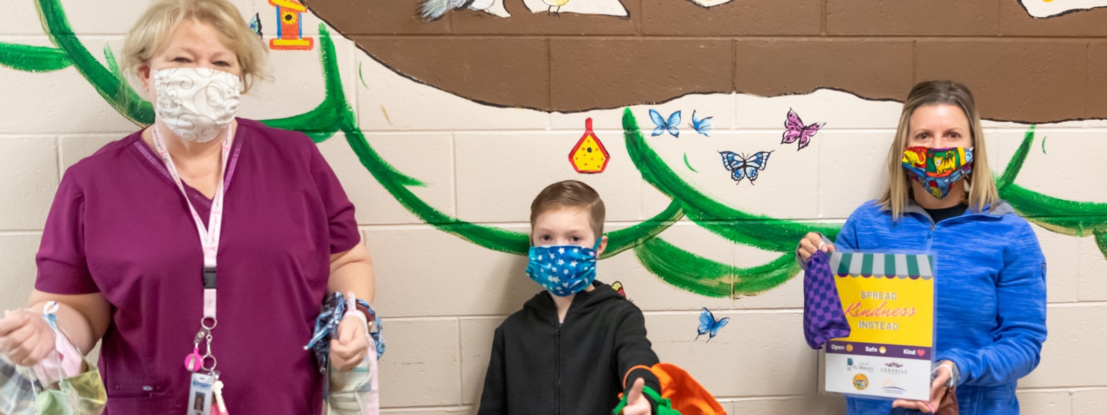 Jane Malone poses with a student and assistant principal at Countryside after donating masks.