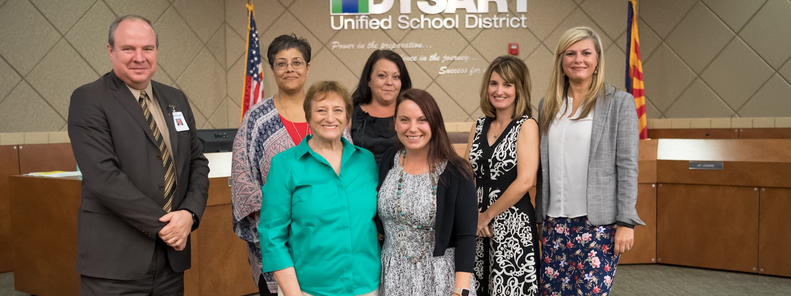 Heather Casey and Sharon Beard pose for a photo with the district governing board and superintendent for being named hometown heroes.