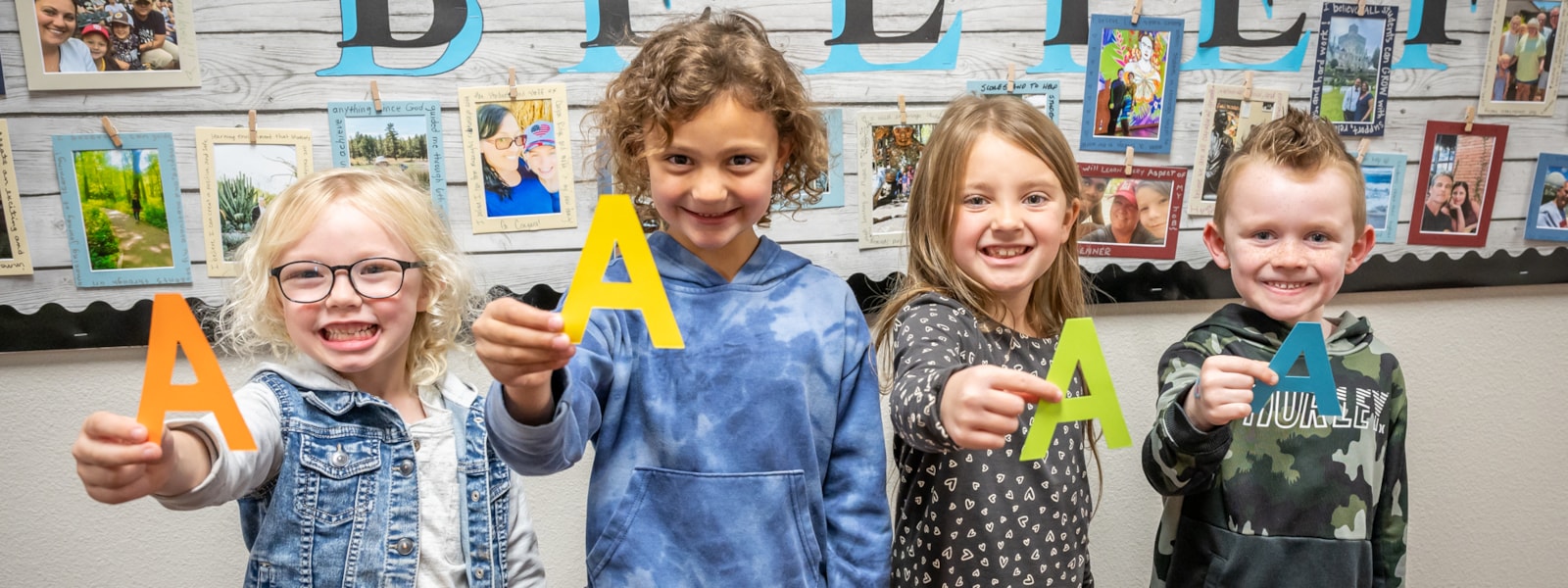 Students holding letter "A"s