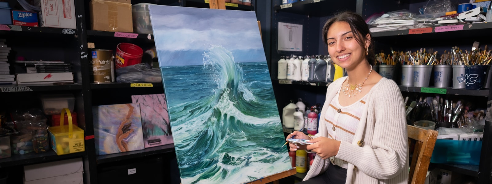 A student with one of her paintings.